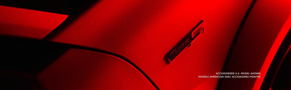 ¾ bird's eye view closeup of the Integra's front fender showcasing the Type S emblem. The entire image is saturated in red light.
