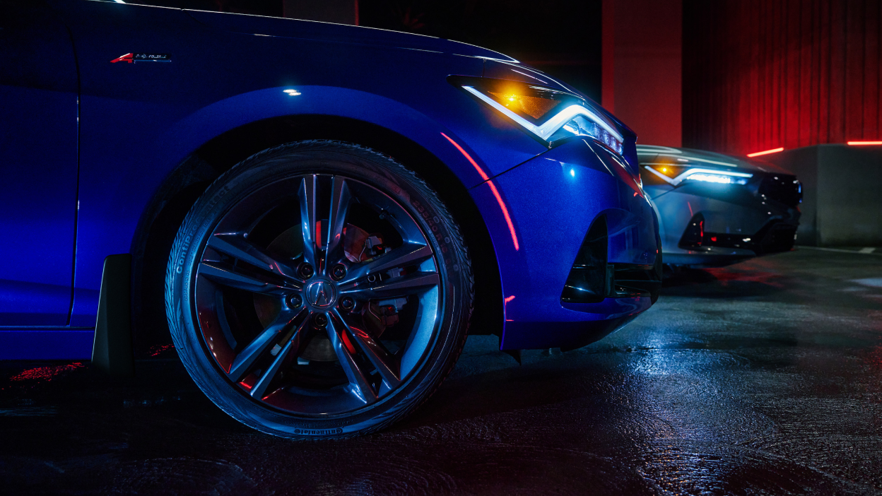 Close-cropped front right wheel with tire on 2023 Integra in dark ambient light