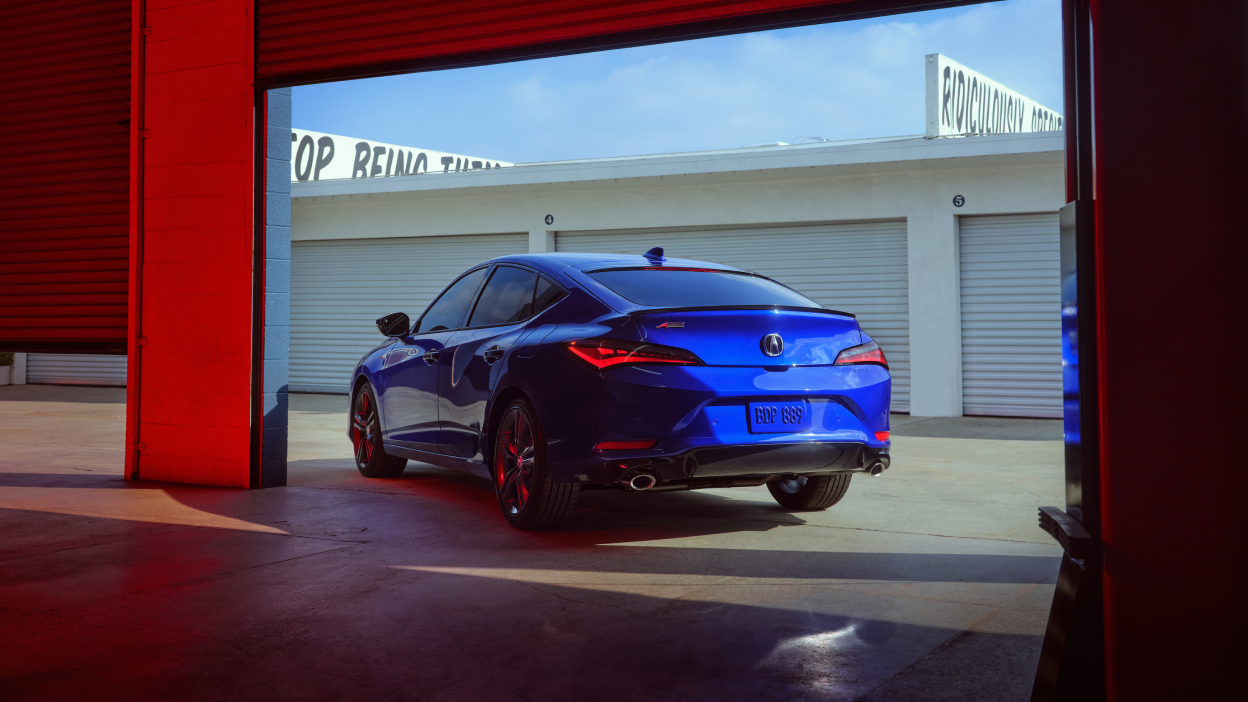 Rear quarter angle of stationary 2023 Integra parked in garage complex