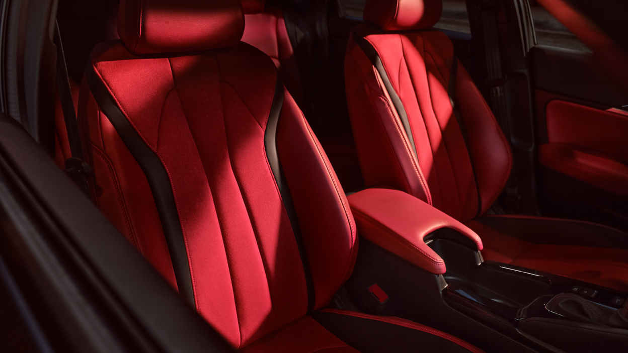 A close-up of Integra Interior of red Ultrasuede™-trimmed power front seats