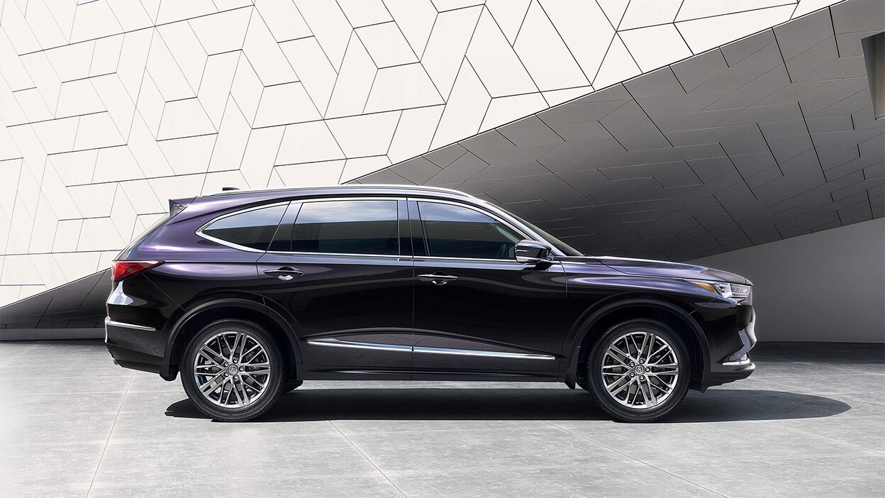 Side view of a purple MDX in a bright, stylish room