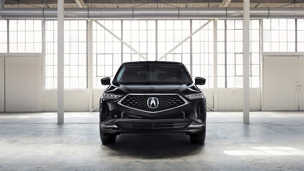Front view of a black MDX in a bright, spacious warehouse.
