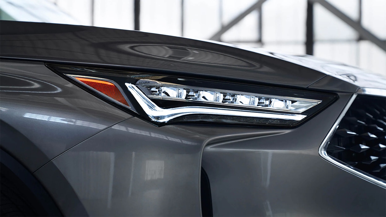 A close-up of a headlight on the Acura MDX.