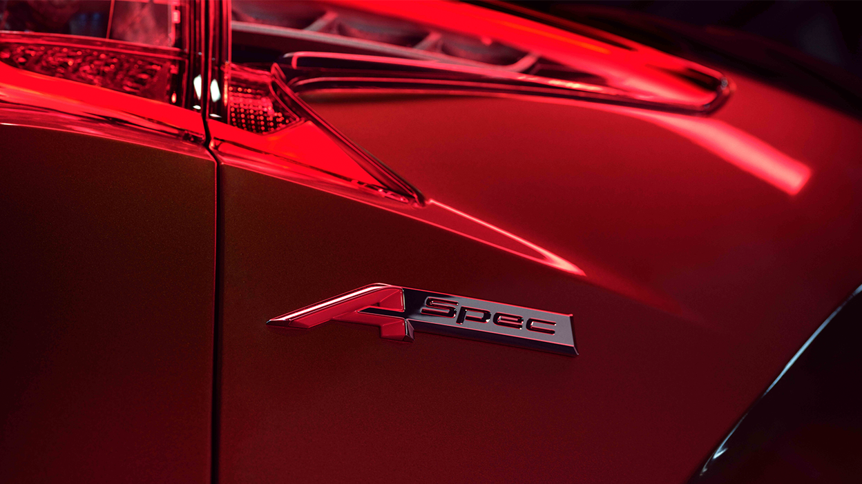 Profile view of front fender on red RDX, displaying “A-SPEC” emblem.