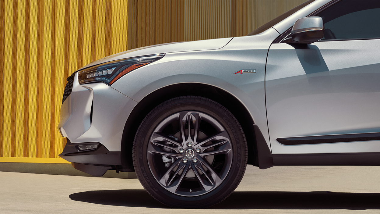 Profile view of front fender of white Acura RDX.