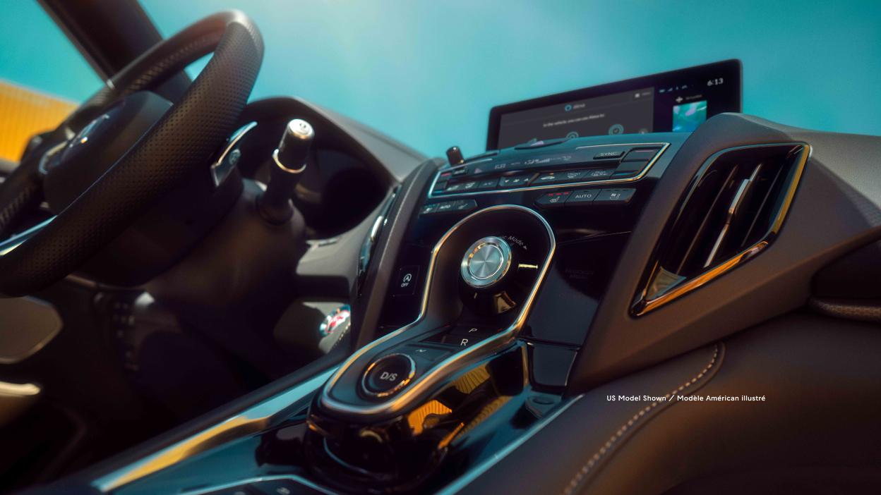 3/4 view of RDX console and steering wheel from front passenger seat perspective. 