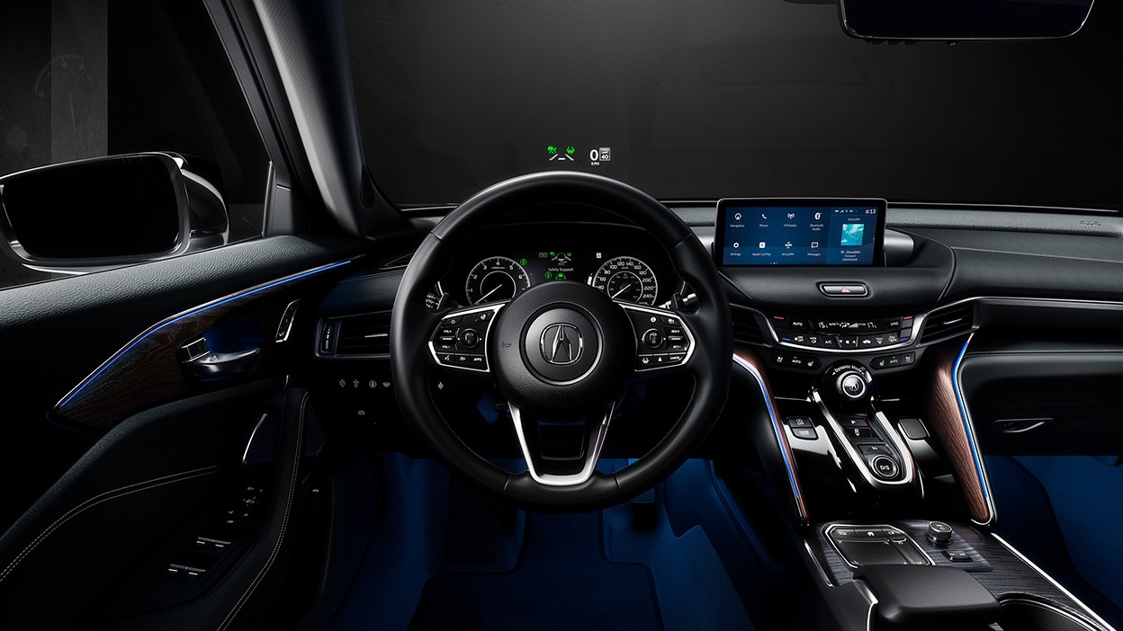 The cockpit of a TLX with Head-Up Display info projected on the windshield.