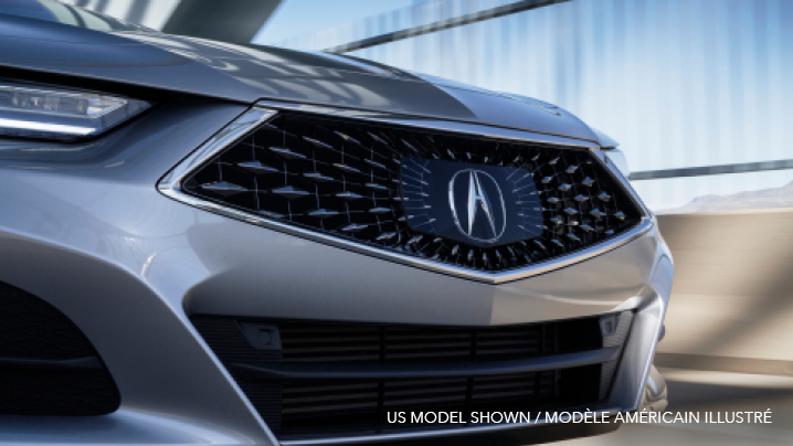 A close-up of the Diamond Pentagon Grille on a grey Acura TLX.