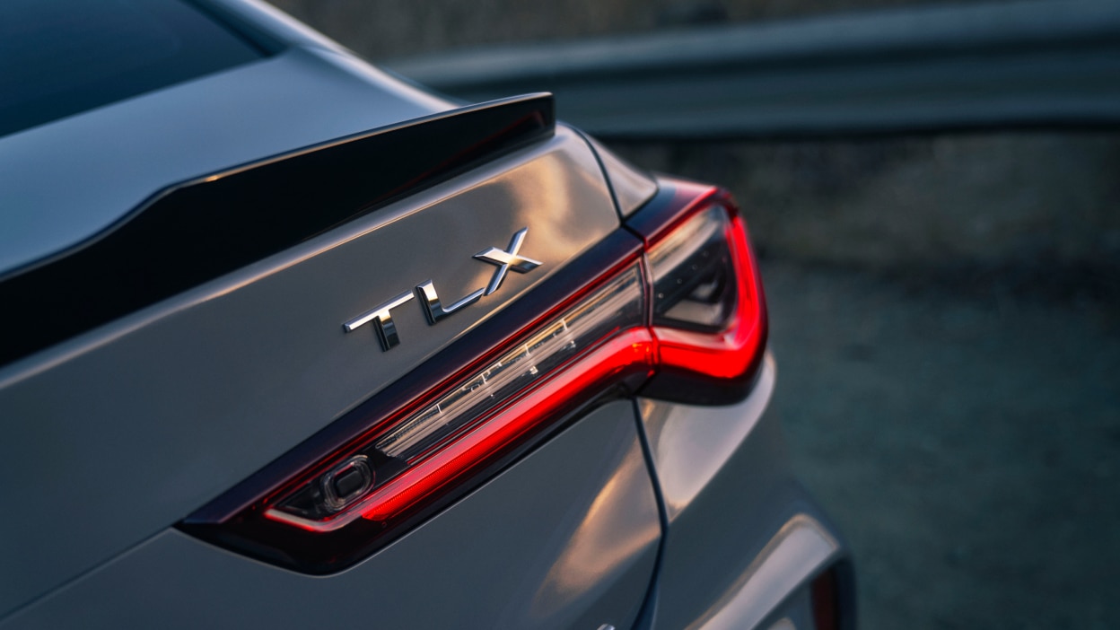 Closeup of TLX badging on trunk of grey TLX.