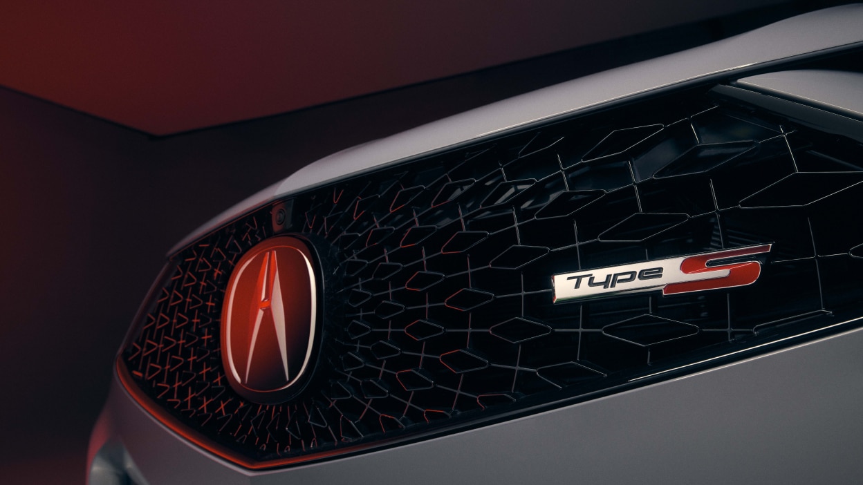 Closeup of Type S badging on front grille of grey TLX Type S.