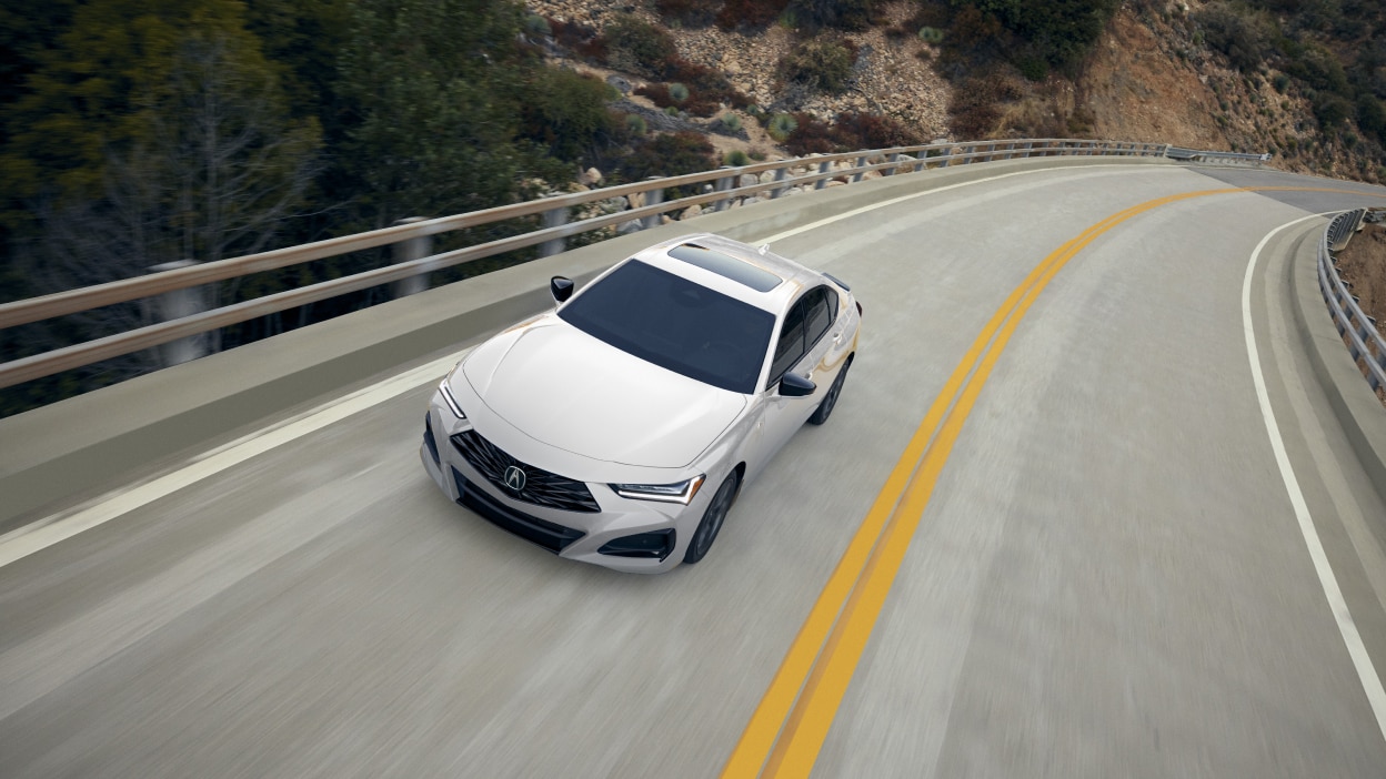 A translucent illustration of the TLX, featuring the suspension system on the front wheels.