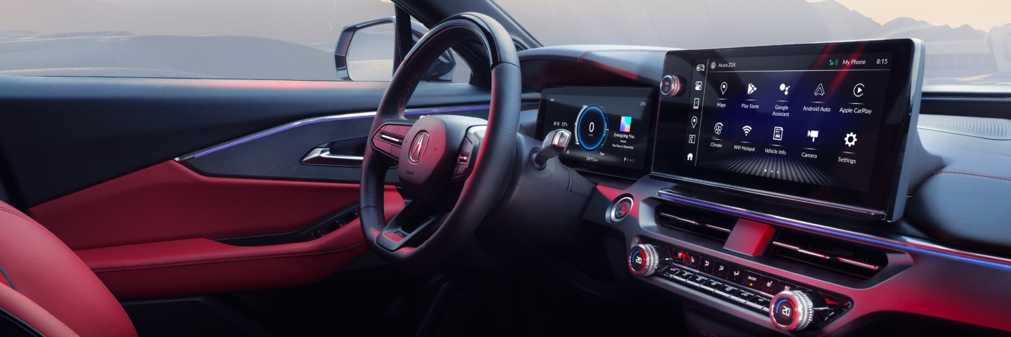 Wide interior view of driver’s side of the cockpit, including leather-wrapped steering wheel, digital instrument cluster, and touchscreen.