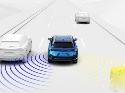 Digital rendering, where everything is white except for the ZDX. Wide rear view of blue ZDX driving on road. Blue and yellow sensor lines detect the cars around it.