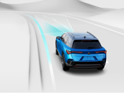 Digital rendering, where everything is white except for the ZDX. Rear view of blue ZDX taking a turn with on a road. Blue sensor lines emit from the front.