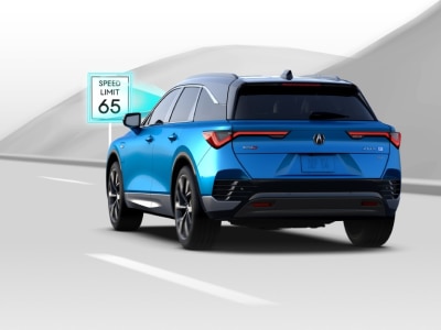 Digital rendering, where everything is white except for the ZDX. 3/4 rear view of blue ZDX. Blue sensor waves emitting from the front detect a traffic speed limit sign.