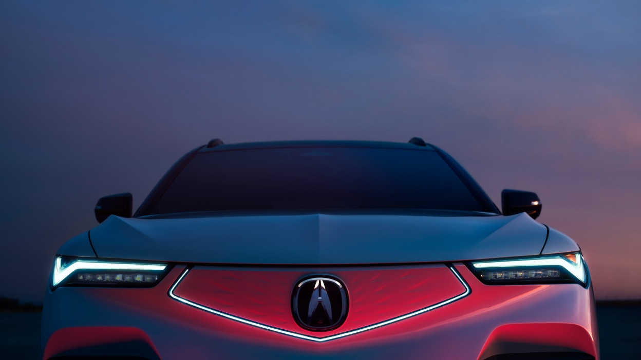 Closeup front view of ZDX at night with headlights on and the diamond pentagon front fascia illuminated.
