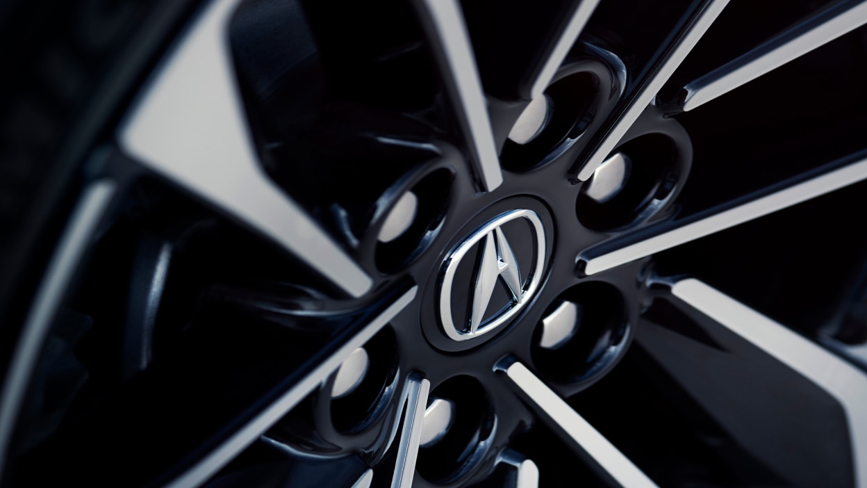 Macro closeup of wheel and Acura logo.