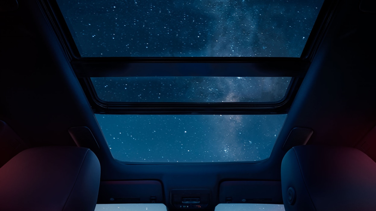 Interior view of moonroof at night. Stars fill the sky.