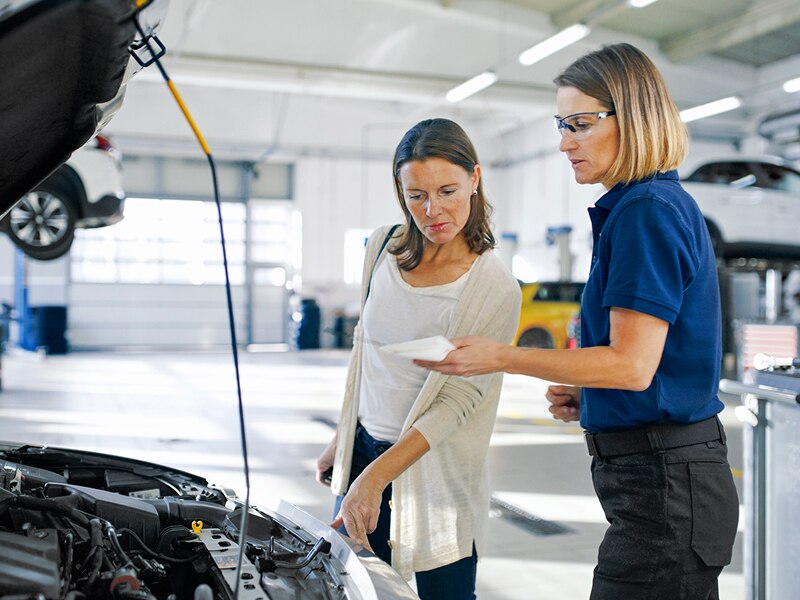 Two women in a car workshop