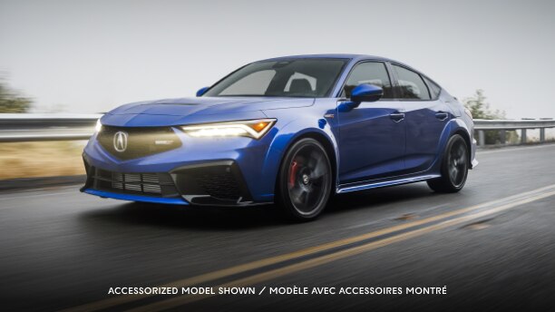A blue Integra Type S driving on a highway.