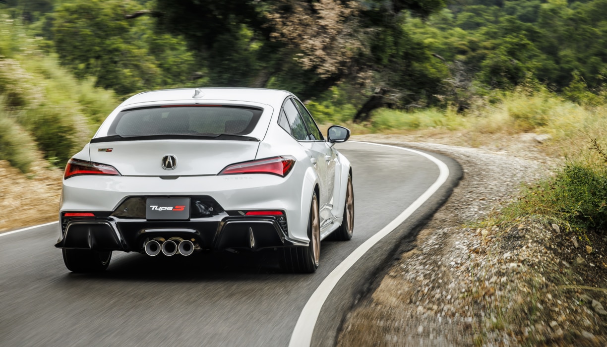 Rear view of white acura Integra 2026 driving on a highway
