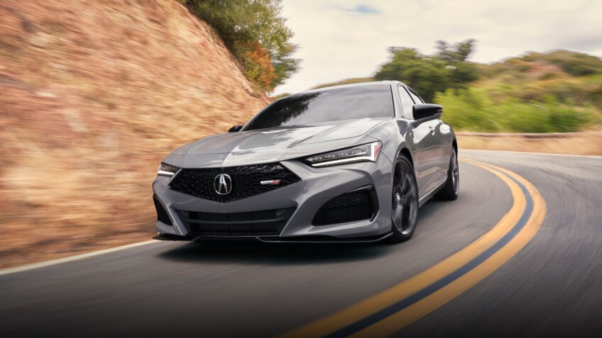 Front view of grey TLX Type S taking a turn on highway.