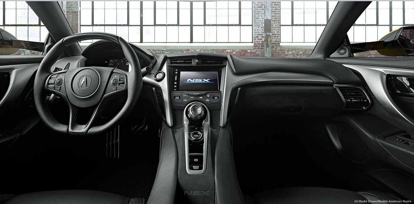 The interior of an Acura's cockpit from the backseat. /  	Vue du cockpit d’une Acura à partir de la banquette arrière.  