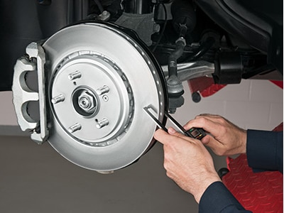 A certified Acura mechanic is inspecting the wear on the rotors. // Un mécanicien certifié Acura inspecte l'usure des disques