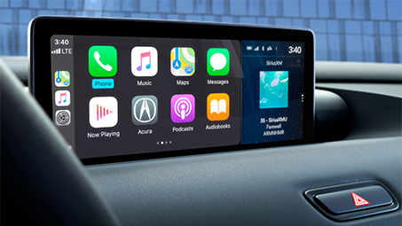 Close-up shot of the touch-screen tablet displaying several apps in the cockpit of an Acura. // Gros plan de la tablette tactile affichant plusieurs applications dans le poste de pilotage d’une Acura.