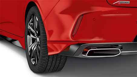 Close-up rear-view of a red Acura, with back left wheel and bumper in view.  // Vue arrière rapprochée d’une Acura rouge, avec la roue arrière gauche et le pare-chocs en vue.