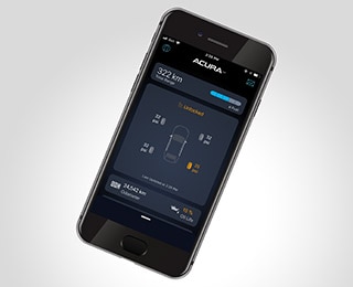 Top-down shot of a black smart phone on a white surface, displaying the AcuraLink™ app on screen./ // Plan de haut en bas d'un téléphone intelligent noir sur une surface blanche, affichant l'application AcuraLinkMC à l'écran.